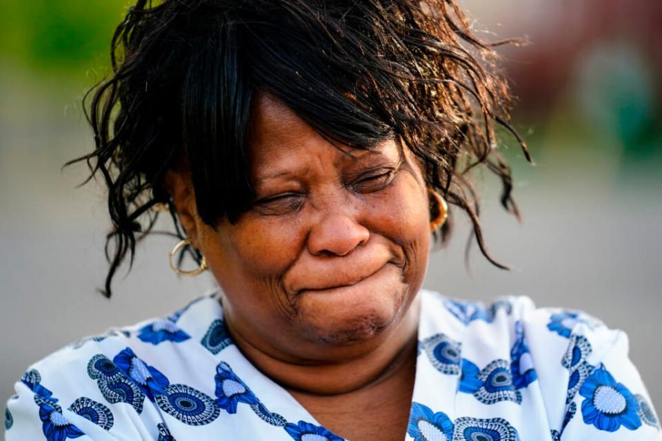 Stephanie Morris is overcome with emotions outside of a scene of a shooting at a supermarket, in Buffalo, N.Y., Sunday, May 15, 2022. (AP Photo/Matt Rourke)