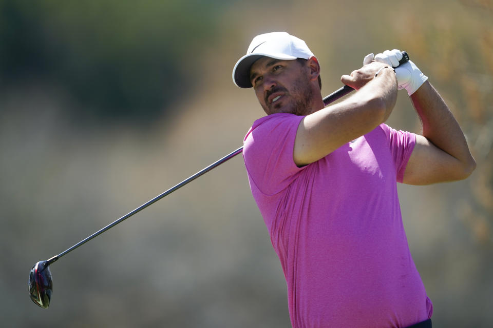 Brooks Koepka watches his shot from the sixth tee during the third round of the Dell Technologies Match Play Championship golf tournament, Friday, March 25, 2022, in Austin, Texas. (AP Photo/Tony Gutierrez)