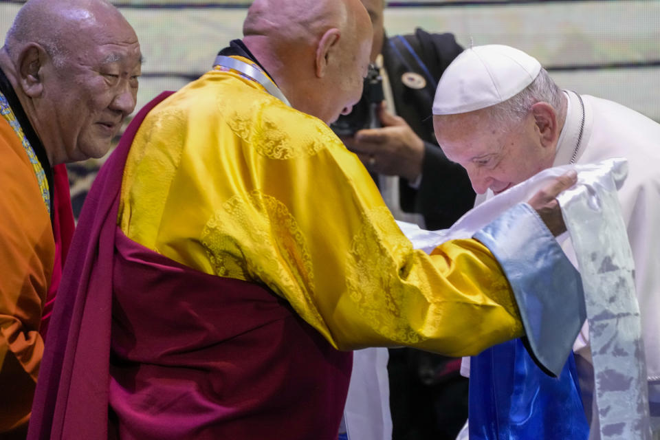 Pope Francis, right, is welcomed by Choijiljav Dambajav, abbot of the Buddhists' Zuun Khuree Dashichoiling Monastery in Ulaanbaatar and Gabju Demberel Choijamts, abbot of the Buddhists' Gandantegchinlen Monastery in Ulaanbaatar, left, as he arrives at a meeting with religious leaders at the Hun Theatre in the Sky Resort compound some 15 kilometers south of the Mongolian capital Ulaanbaatar, Sunday, Sept. 3, 2023. Pope Francis has praised Mongolia's tradition of religious freedom dating to the times of founder Genghis Khan during the first-ever papal visit to the Asian nation. (AP Photo/Andrew Medichini)