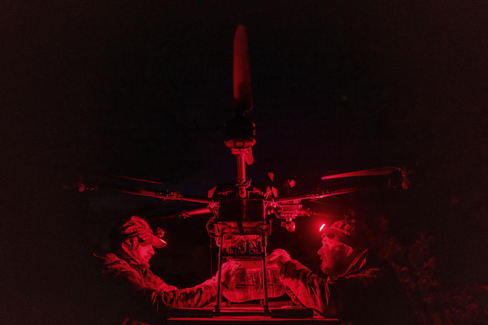 CORRECTS TYPO IN DATELINE FROM KHARKOV TO KHARKIV - Ukrainian national guard servicemen from the Khartia Brigade attach an explosive to a "vampire" drone before bombing Russian positions at the front line near Kharkiv, Ukraine, Friday, May 17, 2024. (AP Photo/Evgeniy Maloletka)