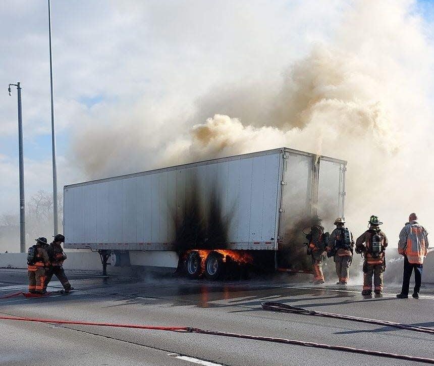 Cincinnati firefighters work a truck fire that closed down all lanes on northbound Interstate 75 near Mitchell Avenue Sunday afternoon.