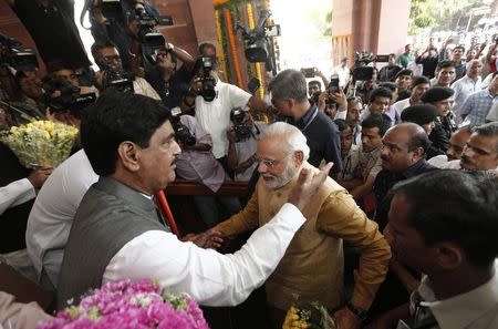 Narendra Modi (C) arrives to attend the BJP parliamentary party meeting at parliament house in New Delhi May 20, 2014. REUTERS/Adnan Abidi