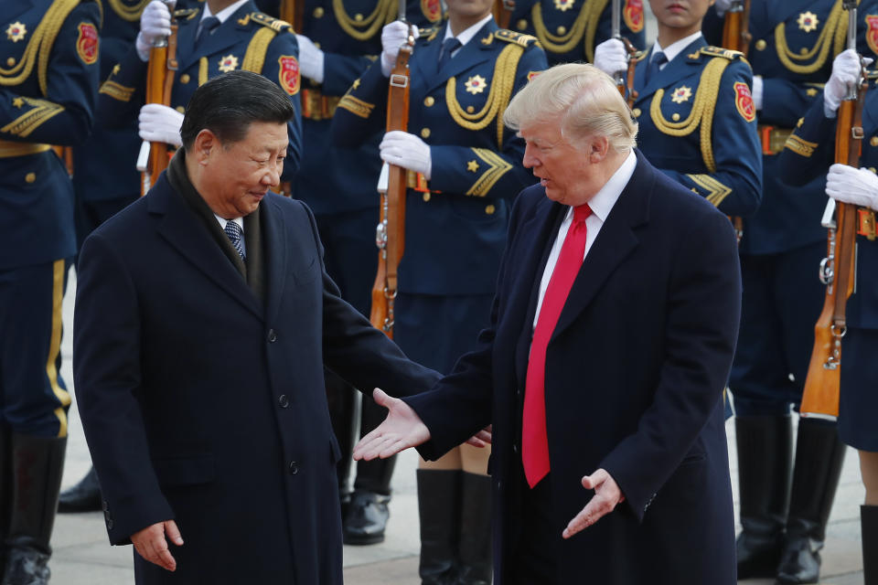 U.S. President Donald Trump, right, and Chinese President Xi Jinping gesture to each others during a welcome ceremony at the Great Hall of the People in Beijing. Trump has touted his friendship with President Xi as a benefit when negotiating new trade agreements for the U.S. (AP Photo/Andy Wong)