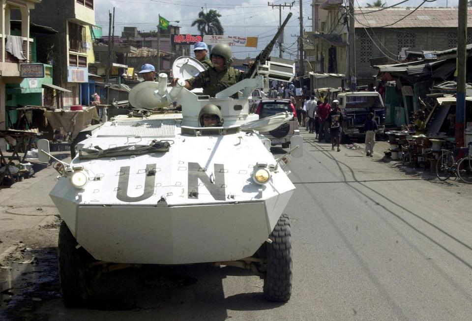 Haitians have bitter memories of U.N. troops in their country. <a href="https://www.gettyimages.com/detail/news-photo/troops-ride-in-an-armored-personnel-carrier-while-news-photo/1543529746?adppopup=true" rel="nofollow noopener" target="_blank" data-ylk="slk:Thony Belizaire/AFP via Getty Images;elm:context_link;itc:0;sec:content-canvas" class="link ">Thony Belizaire/AFP via Getty Images</a>