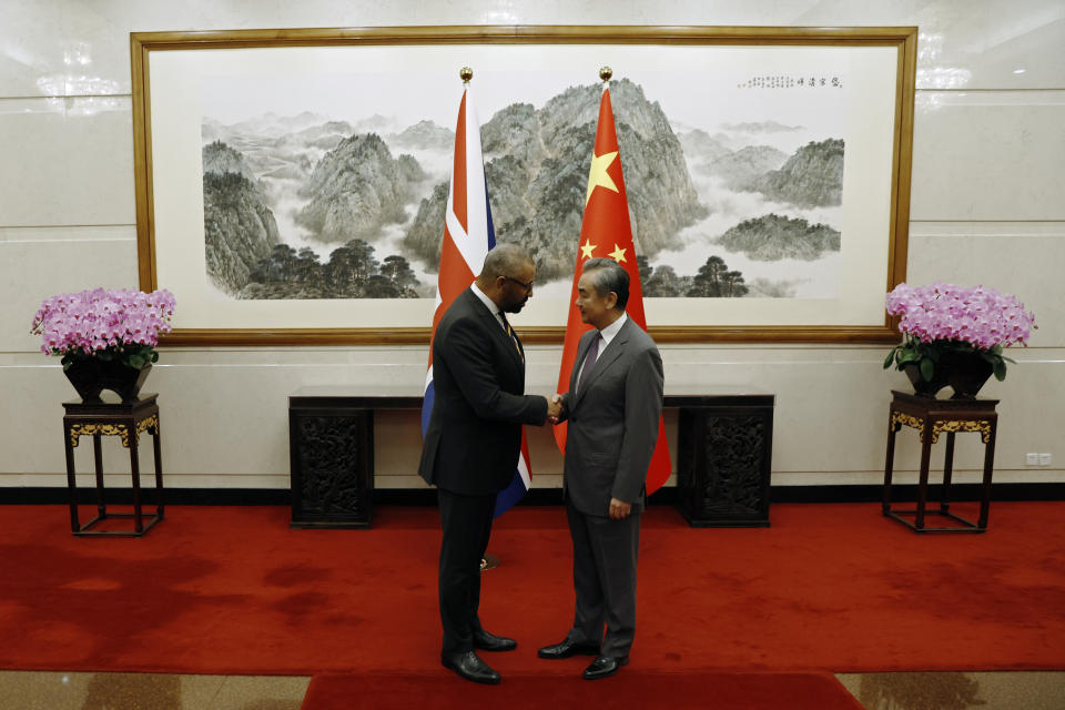 British Foreign Secretary James Cleverly, left, and Chinese Foreign Minister Wang Yi shake hands before a meeting at the Diaoyutai State Guesthouse in Beijing, Wednesday, Aug. 30, 2023. (Florence Lo/Pool Photo via AP)