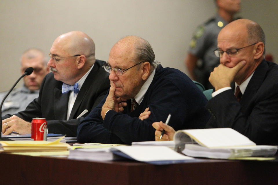 Former Tampa Police captain Curtis Reeves, Jr., center, sits beside his defense attorneys Richard Escobar, right, and Dino Michaels as they listen to his taped interview by detectives during his bond reduction hearing before Circuit Judge Pat Siracusa at the Robert D. Sumner Judicial Center in Dade City Friday, Feb. 7, 2014. Reeves is suspected of fatally shooting Chad Oulson, 43, and wounding his wife, Nicole, 33, during an argument Jan. 13 over texting at the Cobb Grove 16 theater in Wesley Chapel, Fla. (AP Photo/Pool Tampa Bay Times, Brendan Fitterer, Pool)