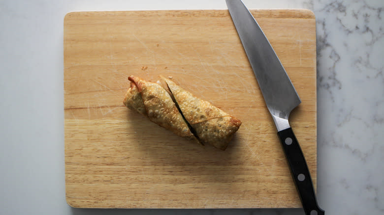 sliced egg roll with knife