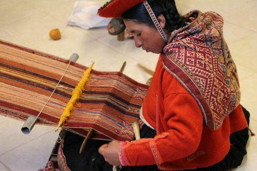 working using a loom in Peru