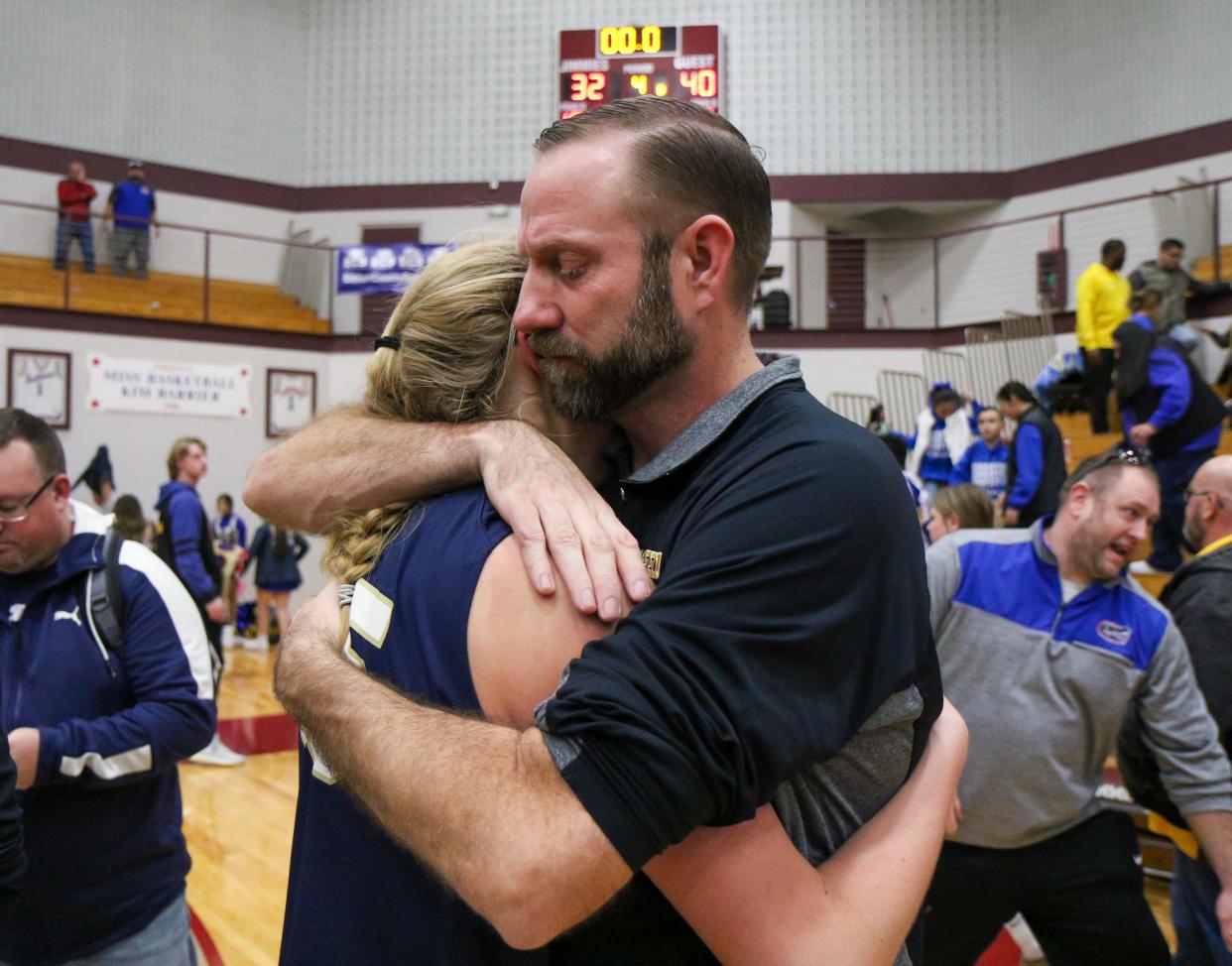 Fairfield's Brea Garber (15) gets a hug from her father, Fairfield head coach Brodie Garber following the IHSAA Regional Finals Saturday, Feb. 11, 2023 at Jimtown High School.