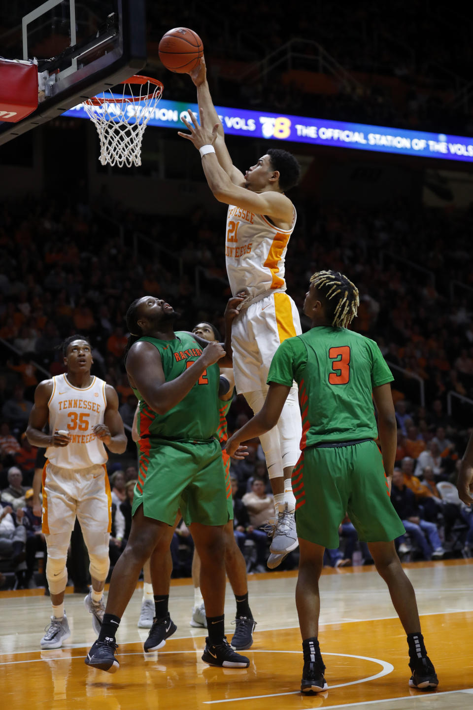 Tennessee forward Olivier Nkamhoua (21) dunks over Florida A&M center Evins Desir (22) during the first half of an NCAA college basketball game Wednesday, Dec. 4, 2019, in Knoxville, Tenn. (AP Photo/Wade Payne)