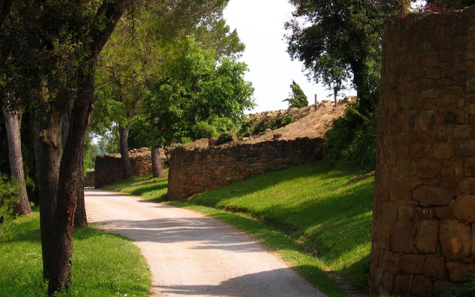 country road and old ruins in Ullastret, Spain