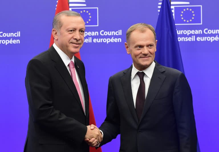 Turkey's President Recep Tayyip Erdogan (L) is welcomed by European Council President Donald Tusk in Brussels, on October 5, 2015