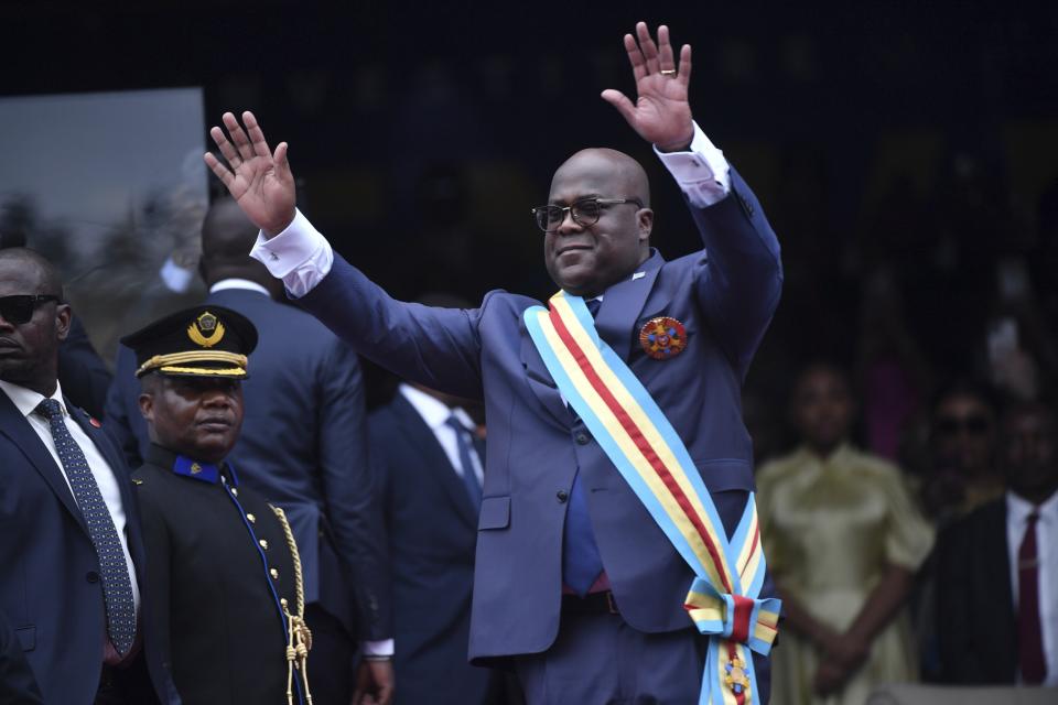 Congo's President Felix Tshisekedi waves to the crowd during his swearing in ceremony for a second term in Kinshasa, Democratic Republic of the Congo, Saturday, Jan. 20, 2024. Tshisekedi promised a huge crowd of supporters and several heads of state to unite the Central African country during his second five-year term and to protect lives in the conflict-hit eastern region. (AP Photo/Guylain Kipoke )