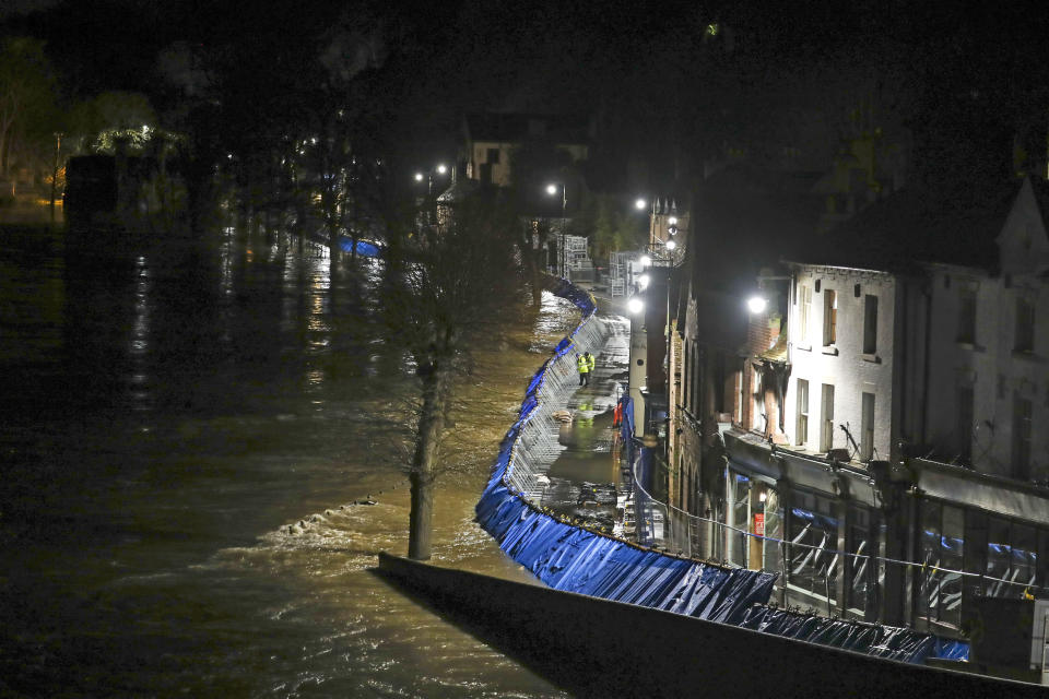 Temporary flood barriers hold back the river Severn in Ironbridge, Shropshire, in the aftermath of Storm Dennis.