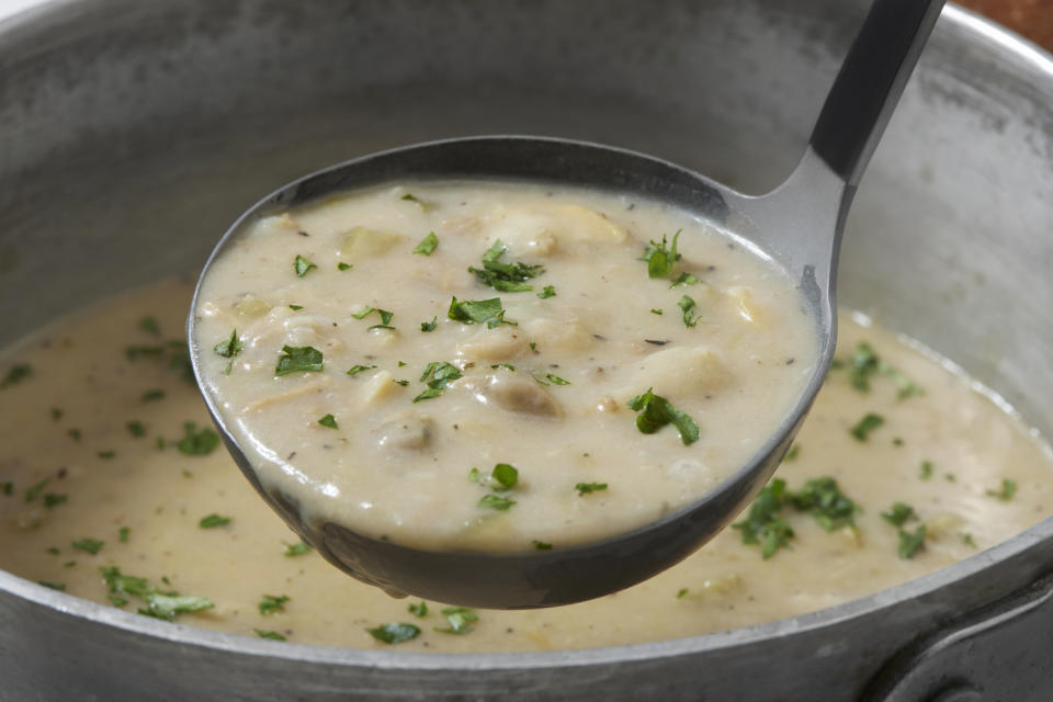 A ladle of New England clam chowder