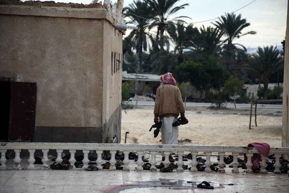 <p>A man collects the remains of belongings of victims from Al-Rawda mosque a day after the mosque was attacked in the northern city of Arish, Sinai Peninsula, Egypt, Nov. 25, 2017. (Photo: Ahmed Hassan/EPA-EFE/REX/Shutterstock) </p>