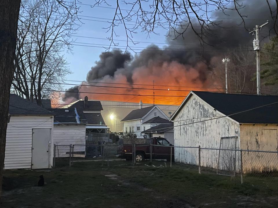 This photo provided by Julie Roe shows smoke rising from a former factory site in Richmond, Ind., Tuesday, April 11, 2023. An evacuation order affecting more than 1,000 people was expected to remain in place through Wednesday, April 12, around the large industrial fire in Richmond, near the Ohio border, where crews worked through the night to douse piles of burning plastics, authorities said. (Julie Roe via AP)
