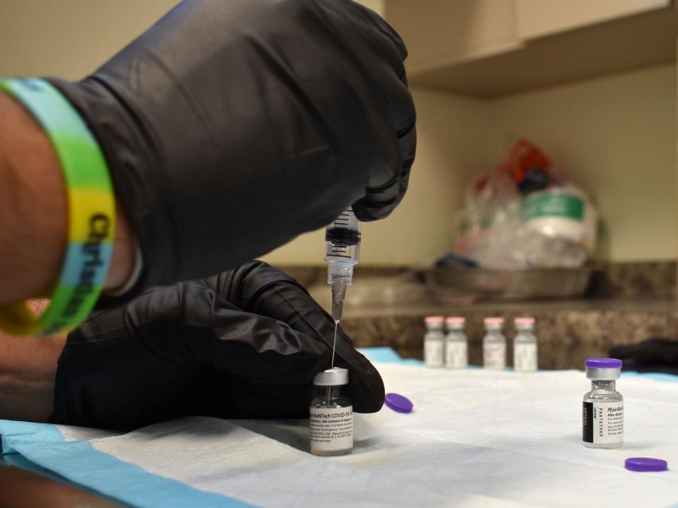 Pharmacy technician Samuel Scarpaci Jr. prepares a dose of the Pfizer COVID-19 vaccine at the Fort Pierce Recreation Center, Wednesday, March 24, 2021, in Fort Pierce, Fla.