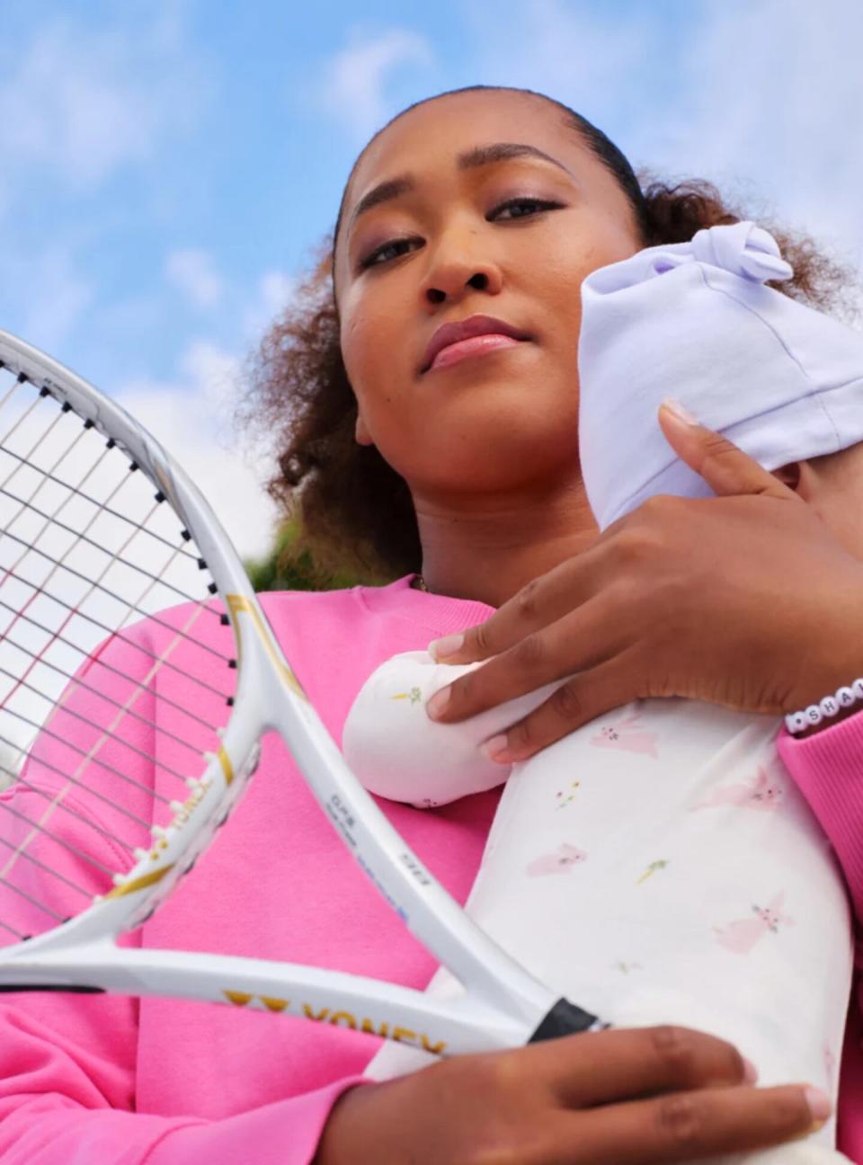 Naomi Osaka holding baby and tennis racket for Bobbie: Parents Push Harder campaign