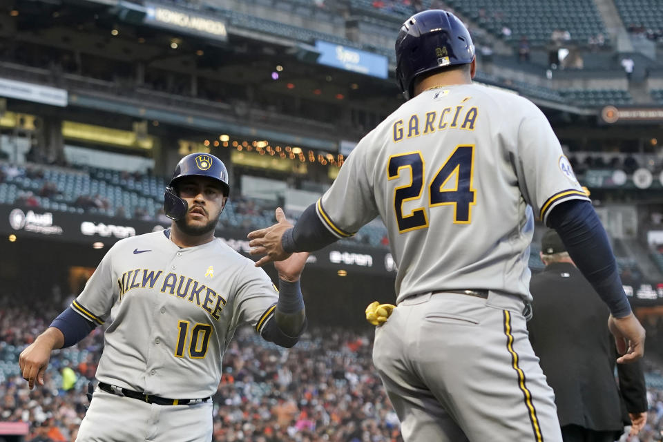 Milwaukee Brewers' Omar Narvaez (10) celebrates with Avisail Garcia (24) after both scored on a two-run single by Lorenzo Cain during the second inning of the team's baseball game against the San Francisco Giants in San Francisco, Wednesday, Sept. 1, 2021. (AP Photo/Jeff Chiu)