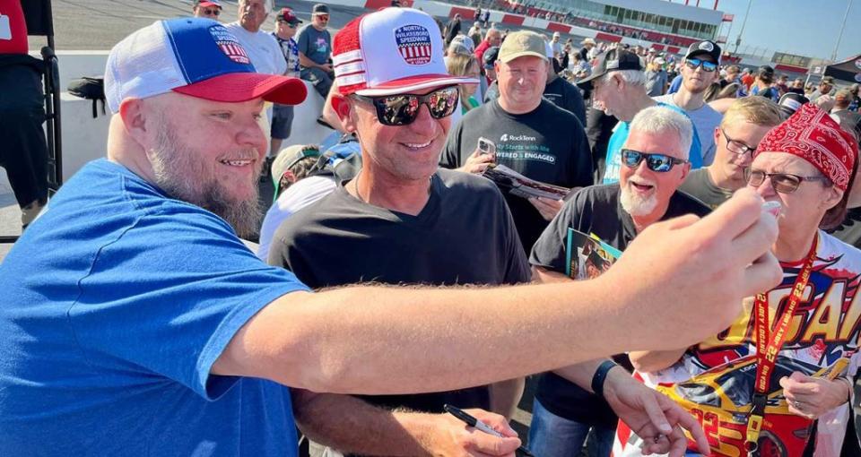 FOX Sports analyst Clint Bowyer takes a selfie with a fan at North Wilkesboro Speedway\