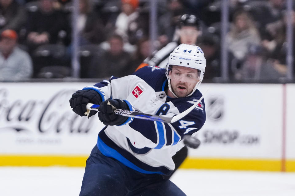 Winnipeg Jets defenseman Josh Morrissey clears the puck during the second period of the team's NHL hockey game against the Anaheim Ducks on Friday, Jan. 5, 2024, in Anaheim, Calif. (AP Photo/Ryan Sun)