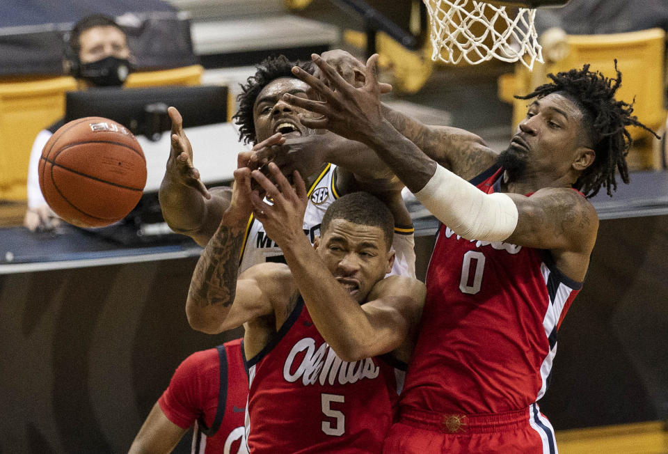 Mississippi's Romello White, right, and KJ Buffen, center, and Missouri's Kobe Brown, left, vie for a rebound during the second half of an NCAA college basketball game Tuesday, Feb. 23, 2021, in Columbia, Mo. (AP Photo/L.G. Patterson)