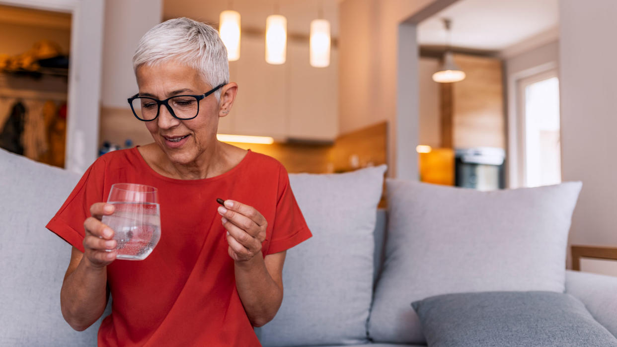  Woman taking menopause supplements 