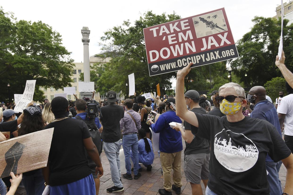 Black Lives Matter supporters continue their protests in Jacksonville, Florida's Hemming Park at the Confederate Memorial, minus the Confederate soldier statue at the top as a backdrop. The bronze plaques around the base were removed during the night by the City of Jacksonville in the first step take down the City's confederate monuments.