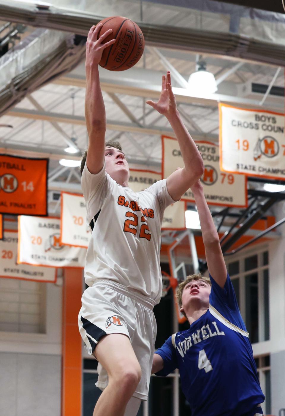 Middleboro's Matt Youngquist scores a basket on Norwell defender Ronan Coffey  during a game on Friday, Feb. 3, 2023.