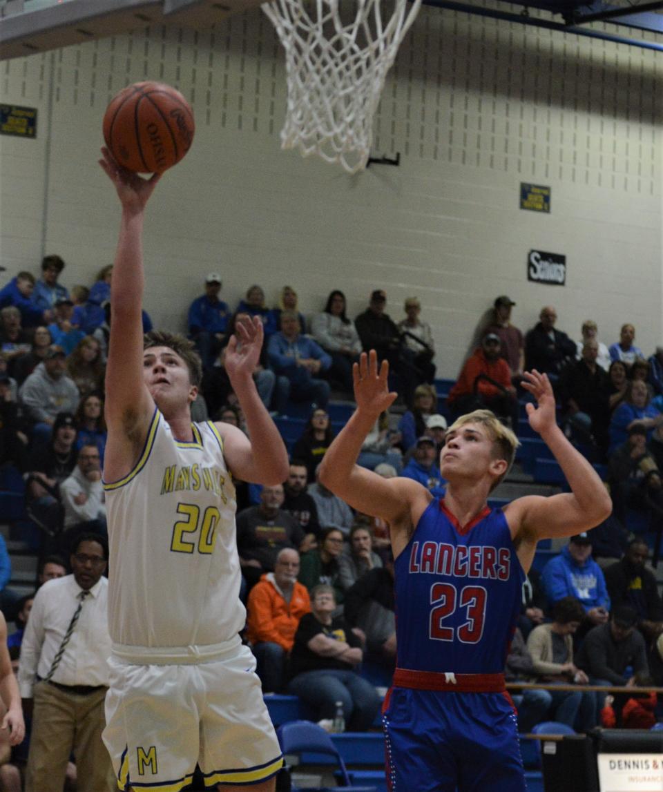 Maysville's Connor Larimer goes up for a hoop against Lakewood's Carson Watts in the Panthers' 75-40 win on Saturday at Maysville.