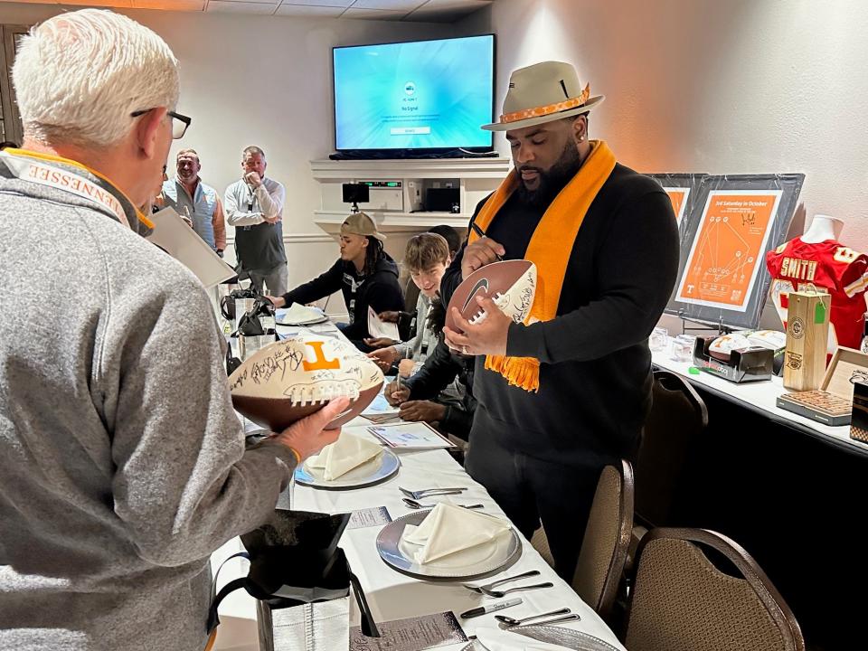 Former Tennessee running back Jabari Davis signs autographs for fans at Bearden Banquet Hall on Feb. 23.