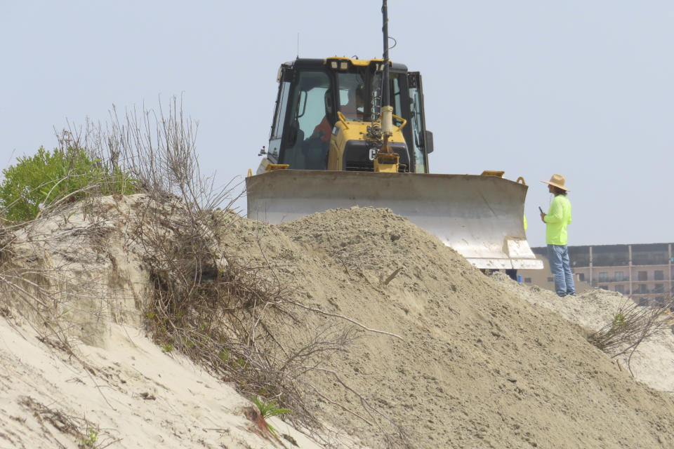 A bulldozer pushes sand along a badly eroded section of beach in North Wildwood N.J. on May 22, 2023. A recent winter storm in January 2024 punched a hole through what is left of the city's eroded dune system, leaving it more vulnerable than ever to destructive flooding as the city and state fight in court over how best to protect the popular beach resort. (AP Photo/Wayne Parry)