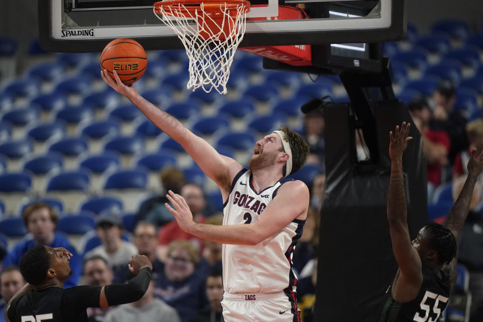 Gonzaga forward Drew Timme (2) goes to the basket as Portland State guard Keshaun Saunders (55) defends during the first half of an NCAA college basketball game in the Phil Knight Legacy tournament Thursday, Nov. 24, 2022, in Portland, Ore. (AP Photo/Rick Bowmer)