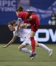 VANCOUVER, CANADA - JANUARY 29: Christine Sinclair #12 of Canada collides with Kelley O'Hara #5 of the United States during second half of championship action of the 2012 CONCACAF Women's Olympic Qualifying Tournament at BC Place on January 29, 2012 in Vancouver, British Columbia, Canada. (Photo by Rich Lam/Getty Images)