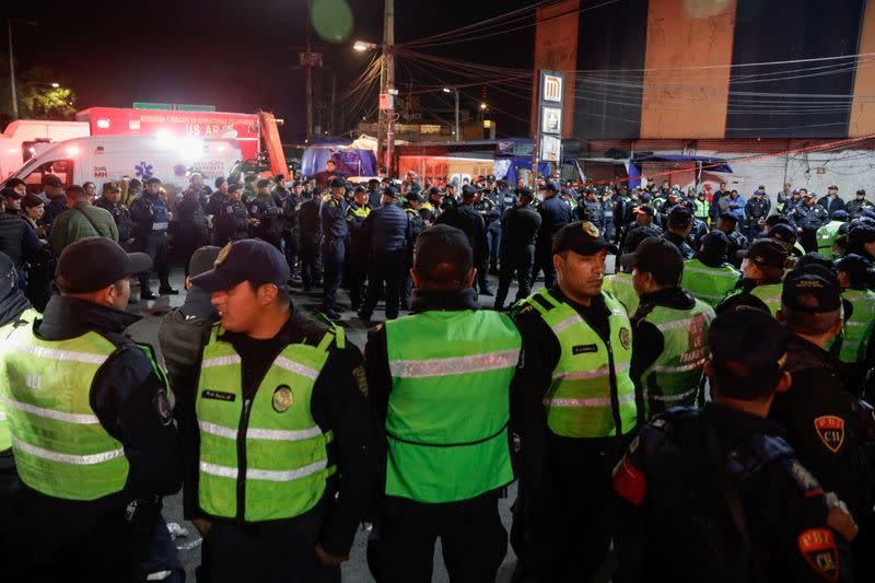 Police officers stand outside the Tacubaya metro station after trains collided, in Mexico City