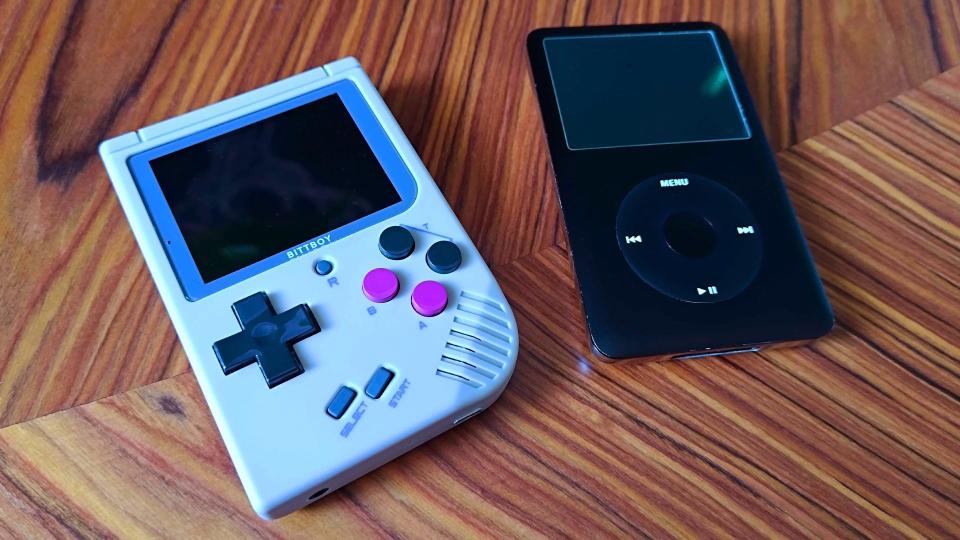 Bittboy next to iPod Classic on woodgrain table