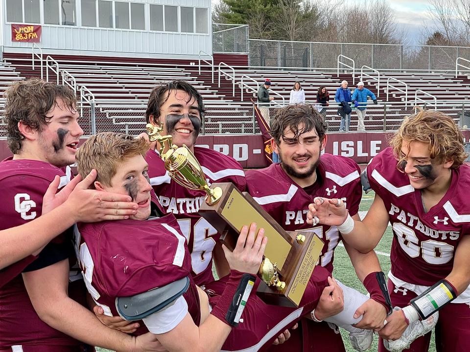 With Holden Miller holding the new rivalry trophy, Concord-Carlisle players enjoy their moment after Thursday's game.