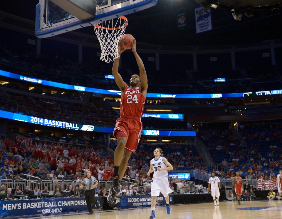 North Carolina State forward T.J. Warren (24) gets to the basket on a fast break ahead of Saint Louis forward Jake Barnett (30) during the first half, of a second-round game in the NCAA college basketball tournament Thursday, March 20, 2014, in Orlando, Fla.