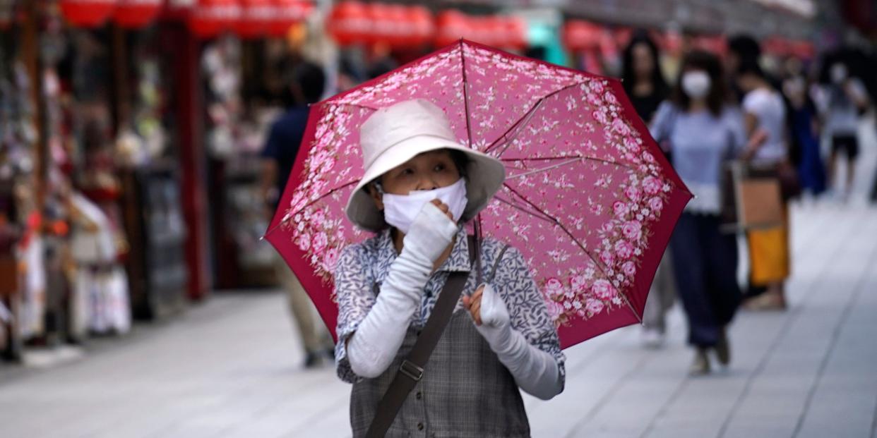 People walk through a shopping arcade near Sensoji Temple in Tokyo Friday, June 12, 2020. (AP Photo/Eugene Hoshiko)