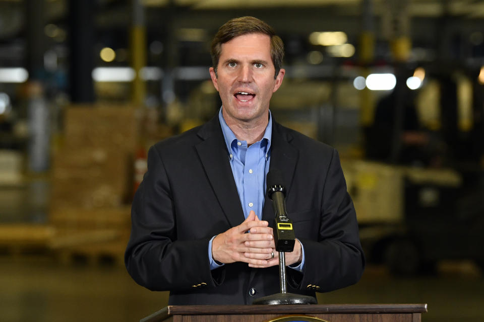 FILE - Kentucky Gov. Andy Beshear speaks with reporters following his tour of the UPS Worldport facility in Louisville, Ky., on April 27, 2021. (AP Photo/Timothy D. Easley, Pool, File)