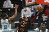 Cleveland Cavaliers guard Darius Garland (10) drives to the basket past Charlotte Hornets guard Brad Wanamaker (9) during the second quarter of an NBA basketball game in Charlotte, N.C., Wednesday, April 14, 2021. (AP Photo/Nell Redmond)