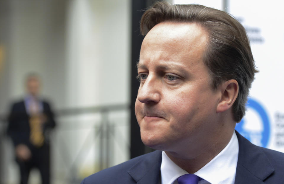 British Prime Minister David Cameron arrives for a meeting at a hotel prior to an EU summit in Brussels on Thursday, Oct. 18, 2012. European leaders are gathering again in Brussels to discuss how to save the euro currency from collapse and support countries facing too much debt and not enough growth. (AP Photo/Geert Vanden Wijngaert)