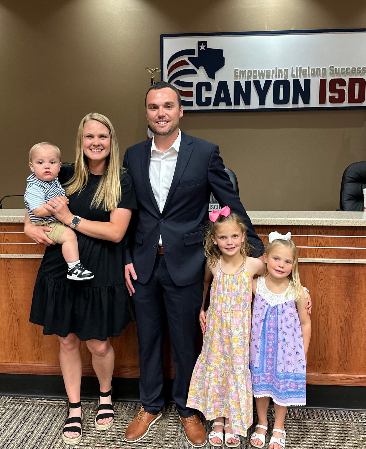 Newly appointed Canyon ISD Athletic Director, John Peterson, with his family Monday at the Canyon ISD Administration Building.