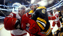 In this photo taken with a fish eye lens, Boston Bruins defenseman Corey Potter (6) struggles with Detroit Red Wings' Riley Sheahan during the first period of a first-round NHL playoff hockey game in Boston on Friday, April 18, 2014. (AP Photo/Winslow Townson)