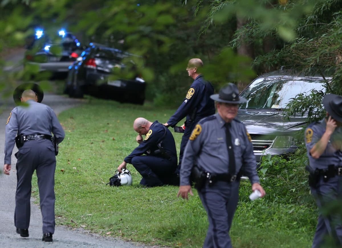 A Virginia law enforcement officer cries near the site of a state police helicopter crash, which killed two state troopers. (Photo: Shelly Cousino / The Daily Progress)