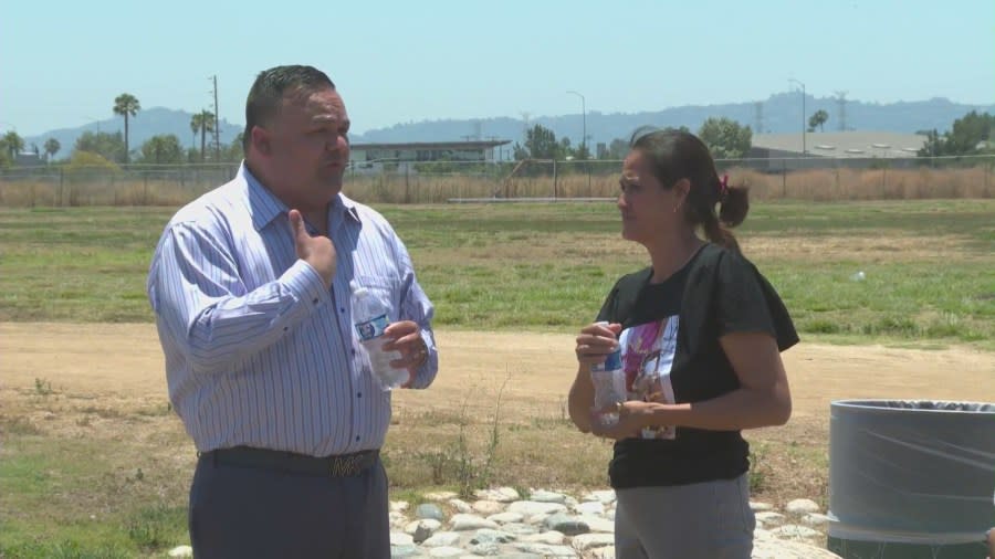 Antonio Villegas, the family’s attorney, speaks to Alfredo Morales' mother. He has pledged to seek justice for the family. (KTLA)