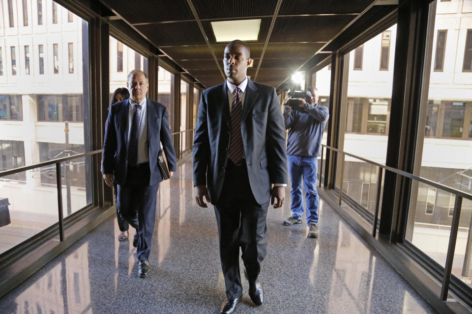 Former Minneapolis FBI agent Terry Albury, front, followed by his attorney Joshua Dratel walk out of the Federal Courthouse in St. Paul Thursday, Oct. 18, 2018 after Albury was sentenced to four years in prison for leaking classified defense documents to a reporter. (Shari L. Gross/Star Tribune via AP)