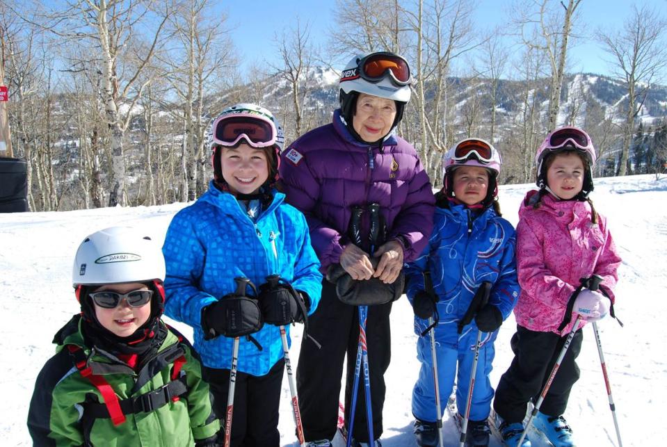 This February 2013 photo provided by the 70 + Ski Club shows Dee Wang, 89, of Shelburne, Vt., skiing with her great-grandchildren in Park City, Utah. The National Ski Areas Association says the number of seniors on the slopes has been creeping up each year while other age groups hold steady or decline. (AP Photo/70 + Ski Club)