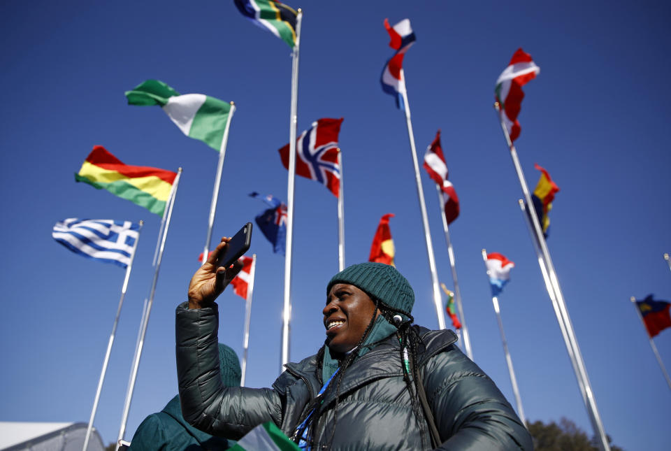 <p>Simidele Adeagbo of the Nigerian Olympic Team snaps a photo before participating in a welcome ceremony inside the PyeongChang Olympic Village prior to the 2018 Winter Olympics. (AP) </p>